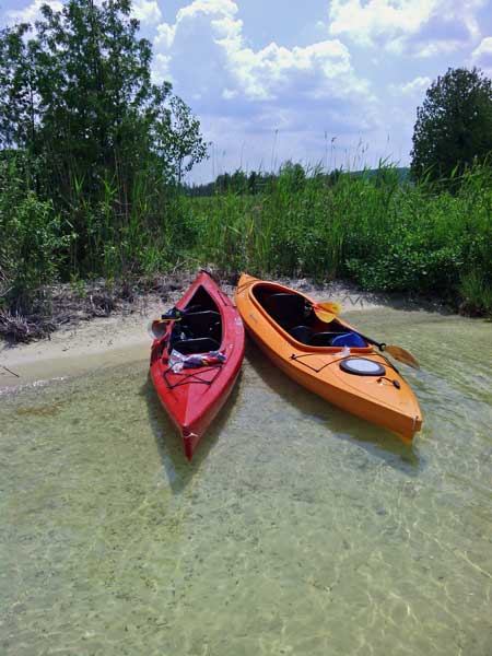 kayaks in the clear water of lake bellaire